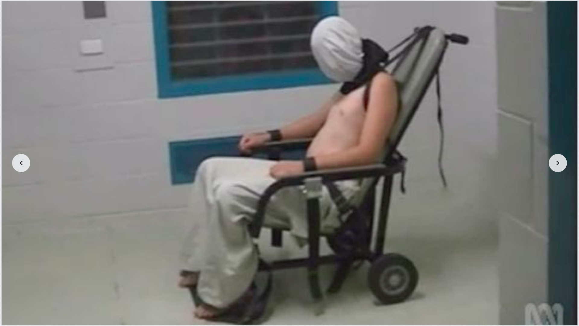 Australian youth strapped into a Guantanamo style 'restraint chair'.png