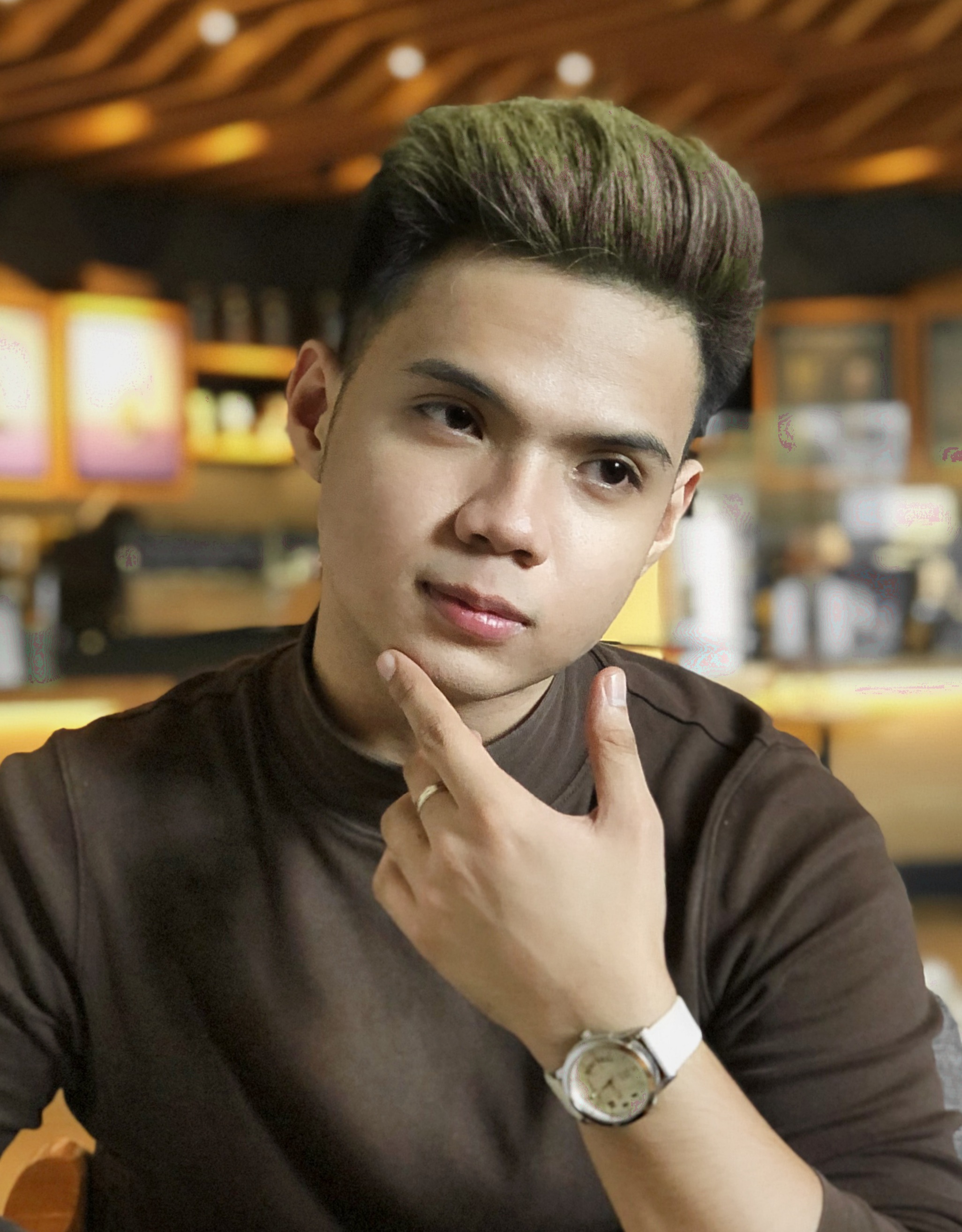 A close-up photo of Vince Cunanan in a coffee shop.