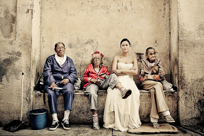 Bride sitting on a bench with Cubans.jpg